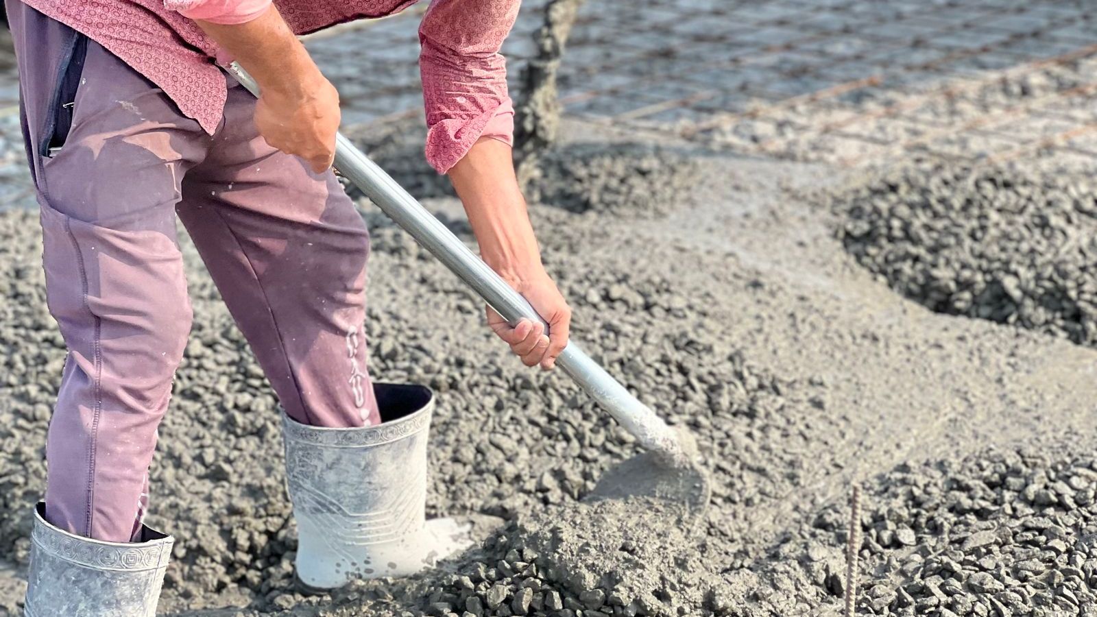 Concrete crew spreading and finishing a fresh pour